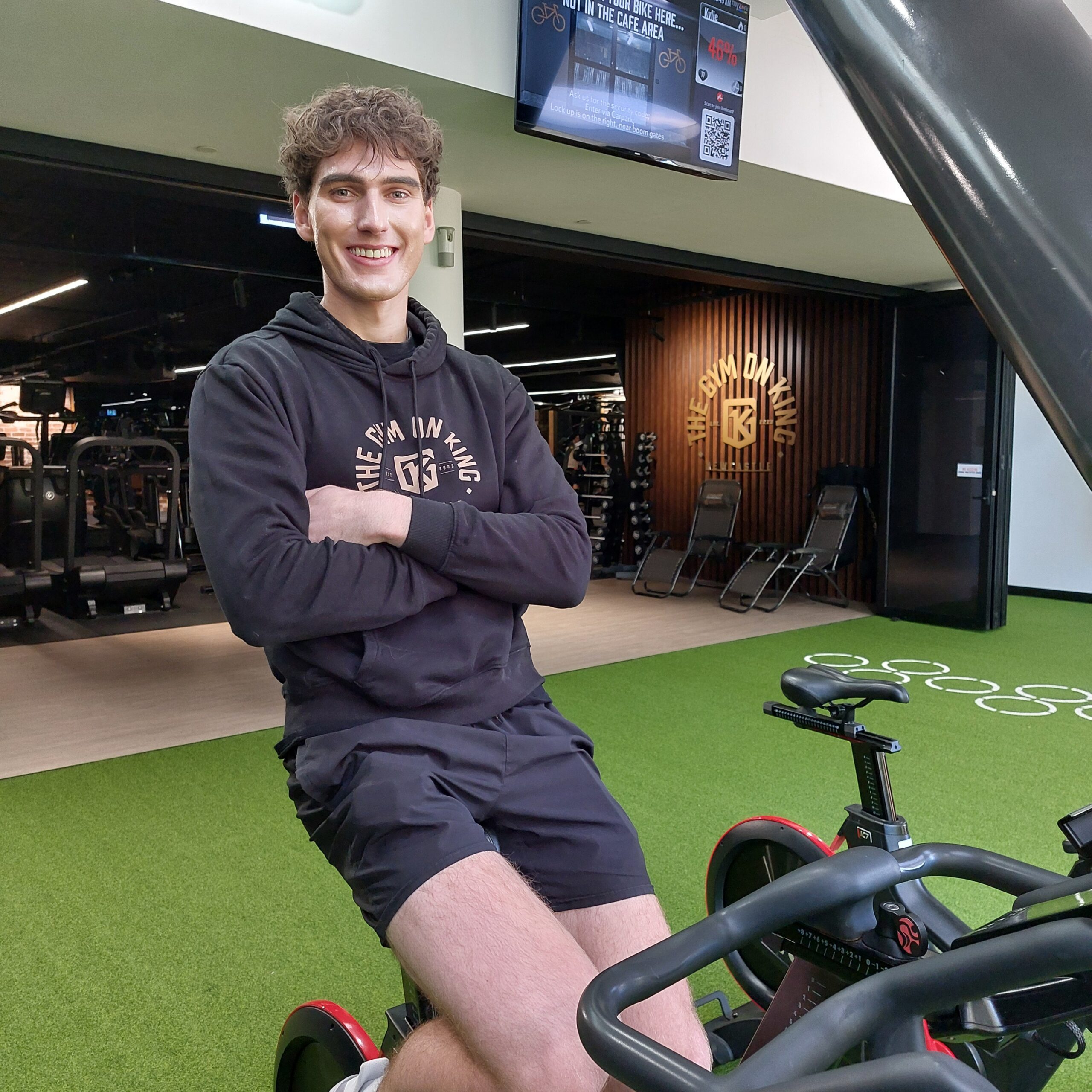 Group exercise trainer sitting on a spin bike